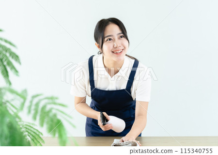 穿著圍裙擦桌子的女人 115340755