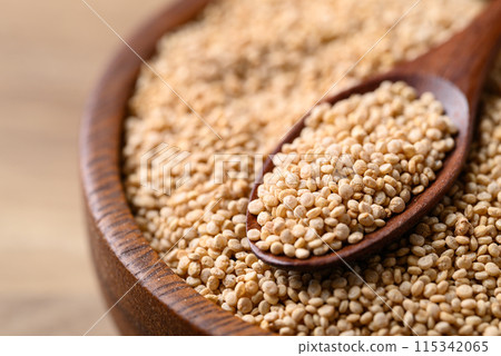 Brown quinoa seed in wooden bowl with spoon, Healthy food ingredient 115342065