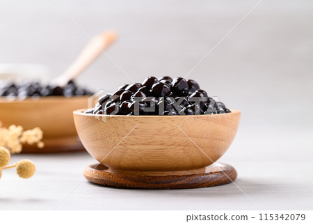 Black tapioca pearls or boba in wooden bowl, Ingredient in bubble tea Black tapioca pearls or boba in wooden bowl, Ingredient in bubble tea 115342079