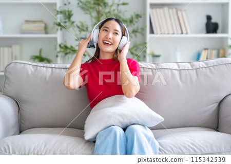 Young Asian woman relaxing on sofa at home 115342539