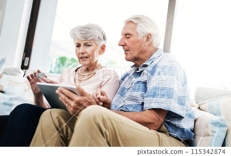 Senior couple, living room and tablet with bank card on sofa for online shopping, payment and retirement plan. People, serious and couch at home for internet banking, budget and investment or finance Senior couple, living room and tablet with bank card on sofa for online shopping, payment and retirement plan. People, serious and couch at home for internet banking, budget and investment or finance 115342874