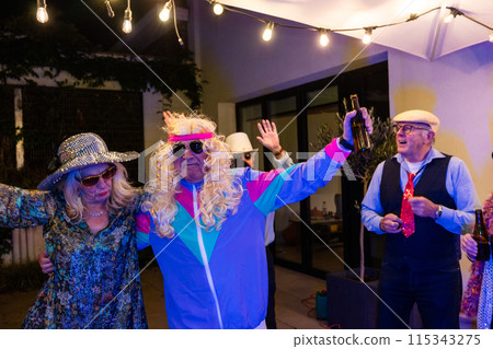 Senior party with friends, dancing, costumes, string lights, making retirement memories 115343275