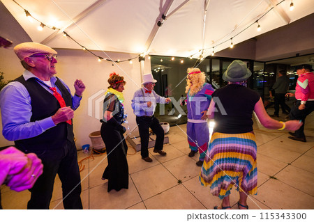 Vibrant Costume Party Celebration with Dancing, Festive Lights, and Joyful Gathering 115343300