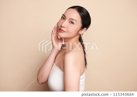 Beautiful young asian woman with clean fresh skin on beige background, Face care, Facial treatment, Cosmetology, beauty and spa, Asian women portrait. Beautiful young asian woman with clean fresh skin on beige background, Face care, Facial treatment, Cosmetology, beauty and spa, Asian women portrait. 115343684