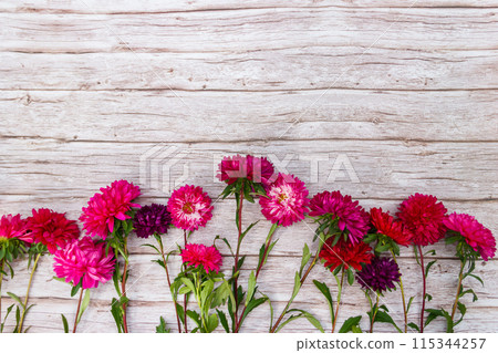 Aster flowers on wooden background. Top view, copy space 115344257