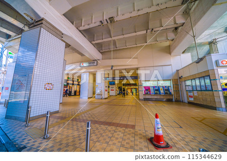 Kawasaki cityscape in June, Japan. View of the east exit of Futako-Shinchi Station under the elevated tracks. Kawasaki cityscape in June, Japan. View of the east exit of Futako-Shinchi Station under the elevated tracks. 115344629