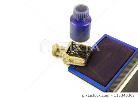 On a white background a stationery numerator, ink pad and an ink bottle On a white background a stationery numerator, ink pad and an ink bottle 115346302