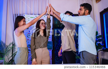 diversity team celebration and high five of sustainability goals is success at green environment office at night 115346466