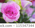 A flower arrangement featuring pink roses 115347344