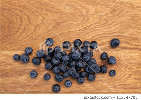 heap of ripe blueberries on wooden background 115347793