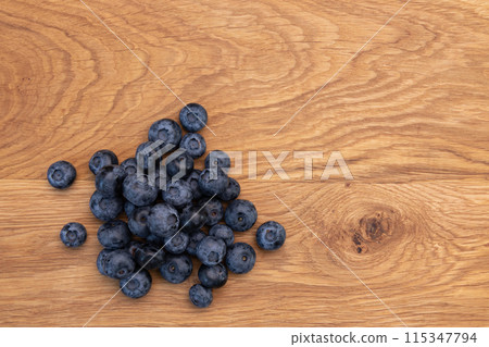 heap of ripe blueberries on wooden background 115347794