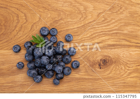 heap of ripe blueberries on wooden background 115347795