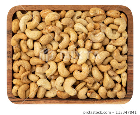 cashew nuts in wooden plate isolated on whit cashew nuts in wooden plate isolated on whit 115347841