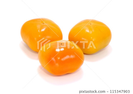 Three seedless persimmons, bright background, autumn flavors 115347903