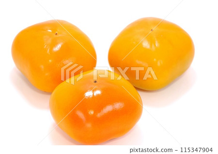 Three seedless persimmons, bright background, autumn flavors Three seedless persimmons, bright background, autumn flavors 115347904