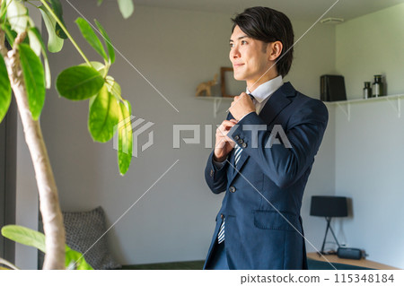 Young male Asian businessman wearing a suit, jacket, suit (tie, style) 115348184