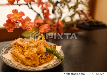 A dining table with kakiage and chrysanthemum flowers 115348424