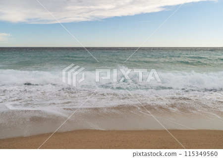 Empty sand beach on Mediterranean sea with horizon line vacation background Empty sand beach on Mediterranean sea with horizon line vacation background 115349560