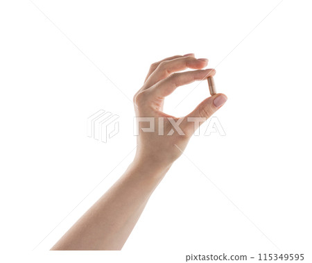 Female hand hold beige pill isolated on white 115349595