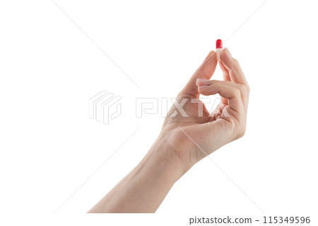 Female hand hold red and white pill isolated on white Female hand hold red and white pill isolated on white 115349596