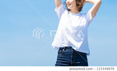 Summer blue sky and a smiling woman in a white T-shirt Summer blue sky and a smiling woman in a white T-shirt 115349870