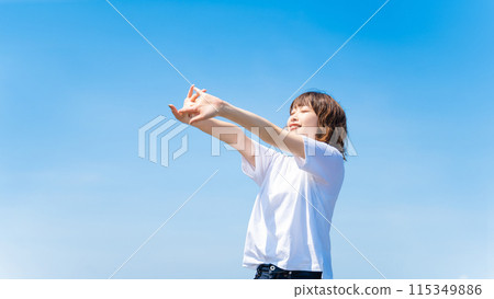 Summer blue sky and a smiling woman in a white T-shirt 115349886