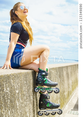 Girl wearing roller skates on seaside 115349890