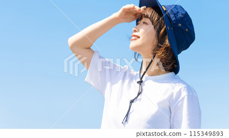 Summer blue sky and a smiling woman wearing a hat 115349893