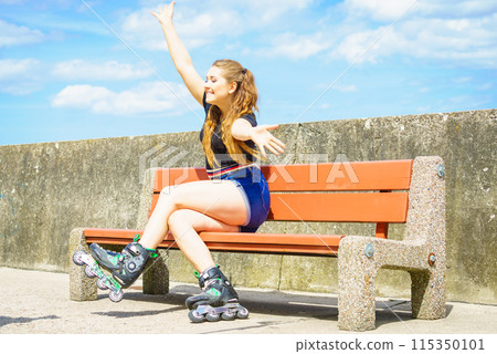 Joyful girl wearing roller skates 115350101