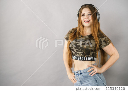 Teen women wearing headphones Teen women wearing headphones 115350120