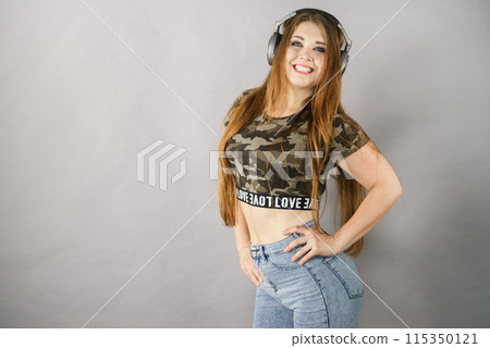Teen women wearing headphones Teen women wearing headphones 115350121