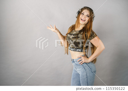 Teen women wearing headphones Teen women wearing headphones 115350122