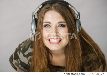 Teen women wearing headphones Teen women wearing headphones 115350124