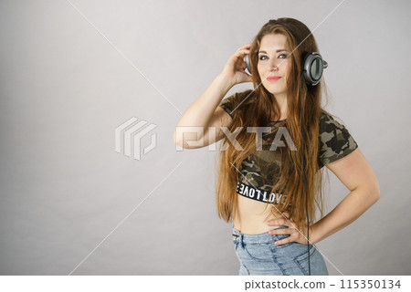 Teen women wearing headphones Teen women wearing headphones 115350134