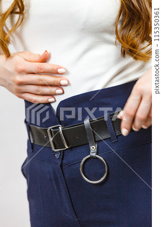 Woman wearing high waist trouser with belt 115350361