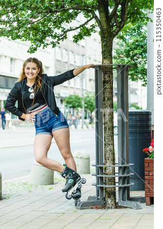 Young woman riding roller skates 115350463