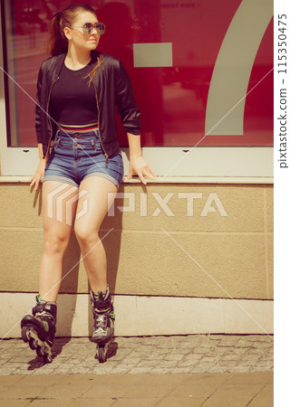 Woman wearing roller skates next to sale 115350475