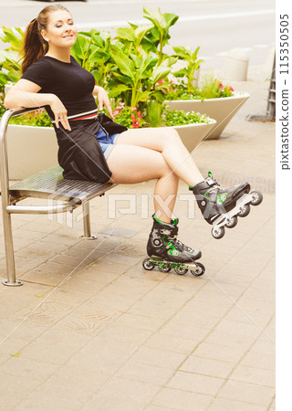 Young woman sitting wearing roller skates Young woman sitting wearing roller skates 115350505