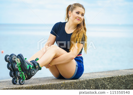 Girl wearing roller skates on seaside Girl wearing roller skates on seaside 115350540