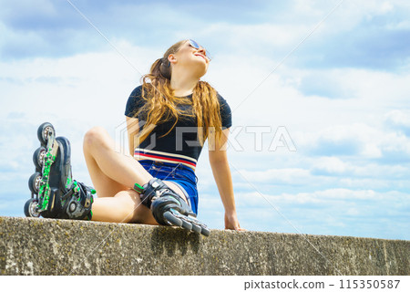 Fit girl with roller skates outdoor 115350587