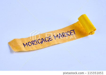 The word mortgage market on torn paper on a blue background 115351051
