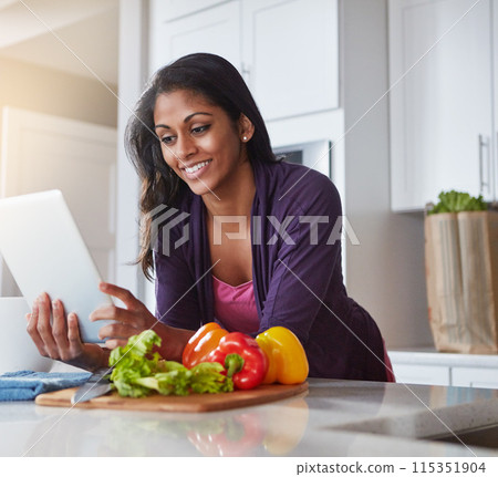 Happy, woman and vegetables with tablet in kitchen for recipe, website or instructions of meal prep. Internet, person and ingredient with tech at home for dinner, cooking and information of food 115351904