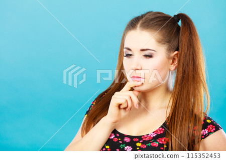Happy teenager girl with brown ponytails thinking Happy teenager girl with brown ponytails thinking 115352453