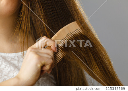 Happy woman brushing her hair 115352569