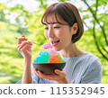 A woman eating shaved ice in hot summer 115352945