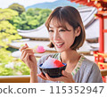 A woman eating shaved ice in hot summer 115352947