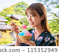 A woman eating shaved ice in hot summer 115352949