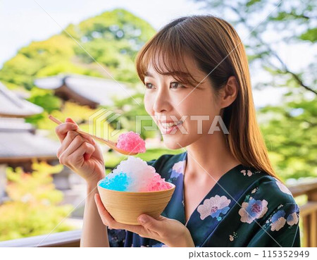 A woman eating shaved ice in hot summer A woman eating shaved ice in hot summer 115352949