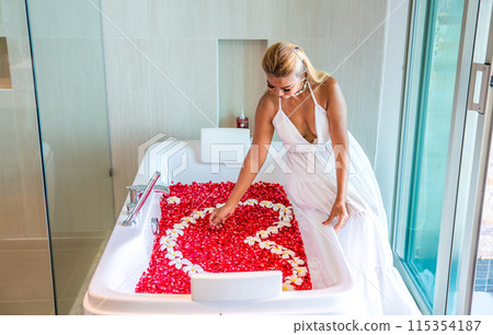 Asian girl in a bathtub with flowers in a shape of a heart in Patong, in Phuket, Thailand 115354187