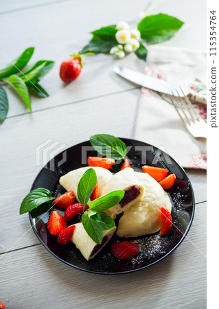 cooked sweet homemade steamed dumplings with strawberries 115354764